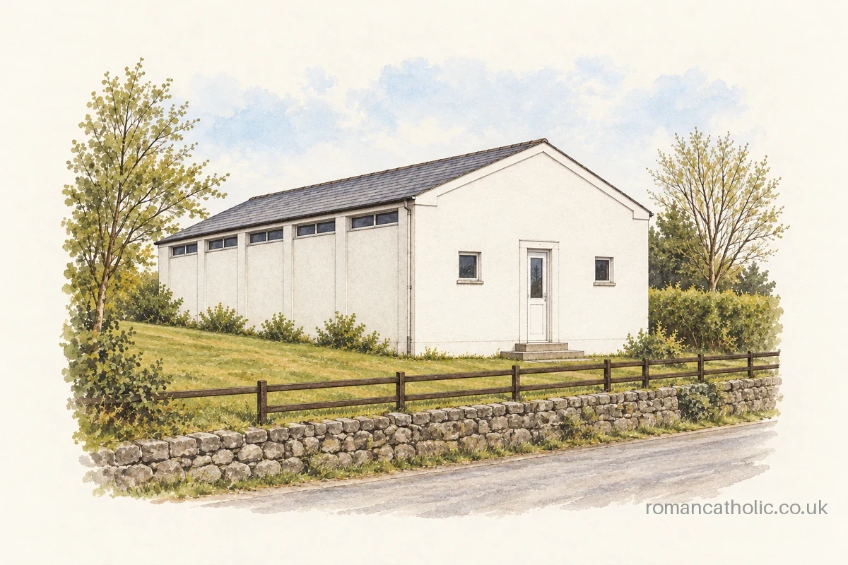 Holy Family in Chagford, a plain white chapel above a grassy roadside bank.